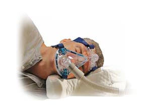 CPAPMax Pillow Shown with User and Mask (Not Included)