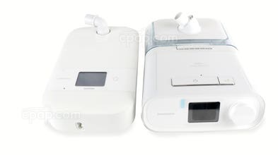 The DreamStation Go is on the left, shown with the humidifier. The DreamStation Auto is on the right, also shown with the humidifier. This product does not include the humidifier or the DreamStation A
