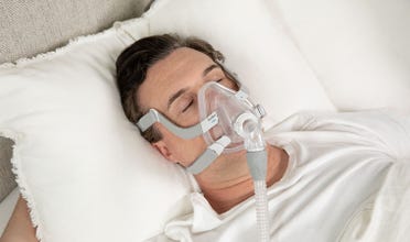 Man sleeping soundly wearing AirFit F20 mask