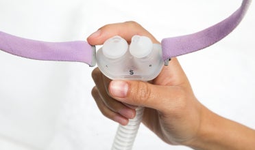 Woman's hand showing AirFit P10 cushion to camera