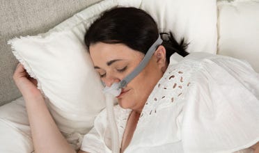 Woman sleeps while wearing AirFit P10 For Her