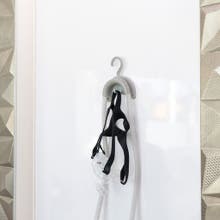 wall-mounted hose hanger holding a mask and hose
