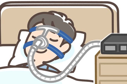 a man with cpap mask in bed with a CPAP machine on a nightstand