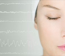 woman closing her eyes with ECG waves