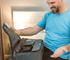 man packing his bags with cpap equipment