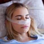 Women sleeping with a Nasal CPAP mask